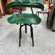 Vintage swivel workshop chair in green pressed sheet metal with a folding backrest.