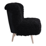 Mid-century black cocktail chair in lambskin, beech legs — 1960s