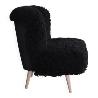 Mid-century black cocktail chair in lambskin, beech legs — 1960s