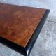 Vintage coffee table in wood burl on a black lacquered base.