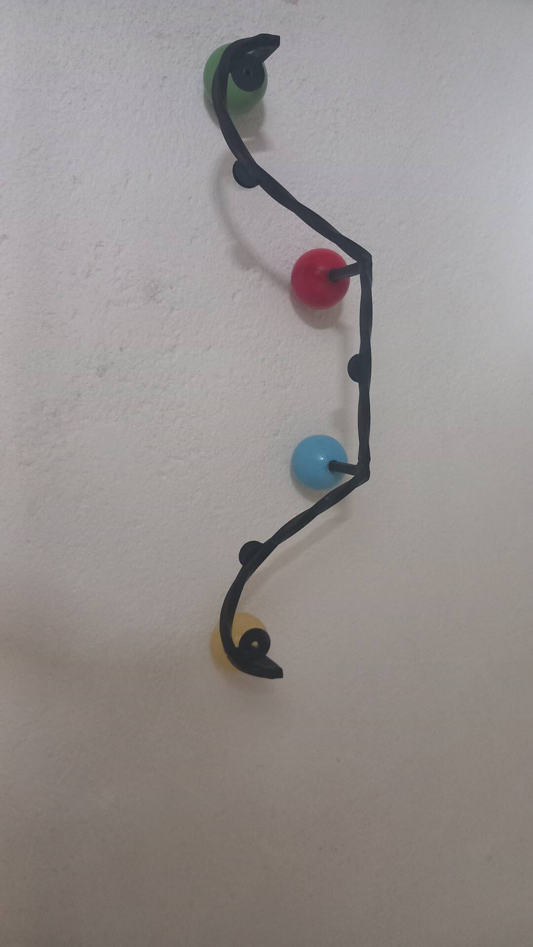 Vintage wall coat rack "Atomic" in wrought iron with multicoloured balls.