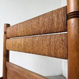 Brutalist style bed with chain and straw