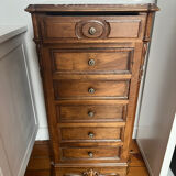Solid wood storage furniture with a marble top.