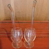 Pair of glasses with integrated straw