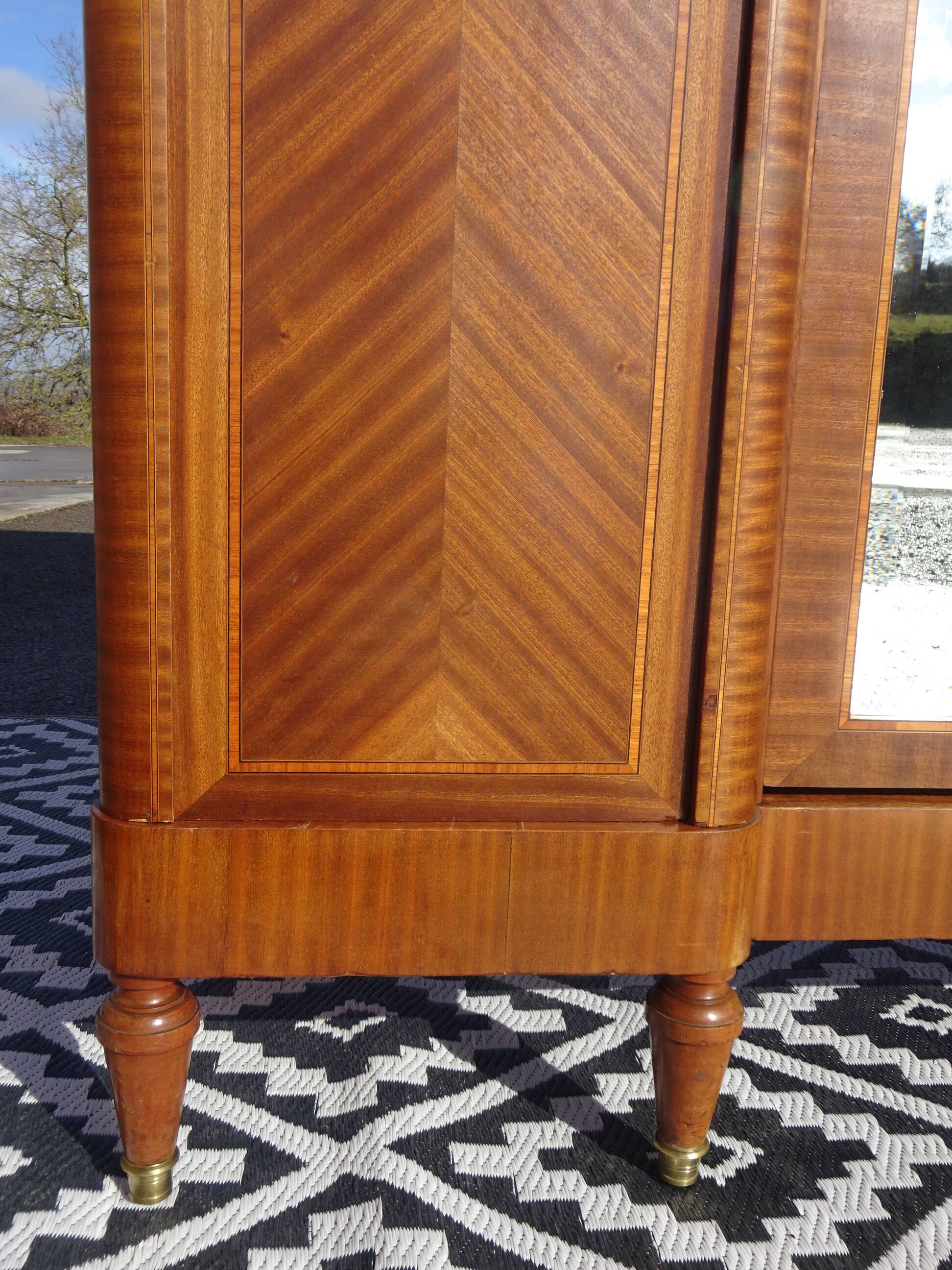 Three-door wardrobe with marquetry and bronze.