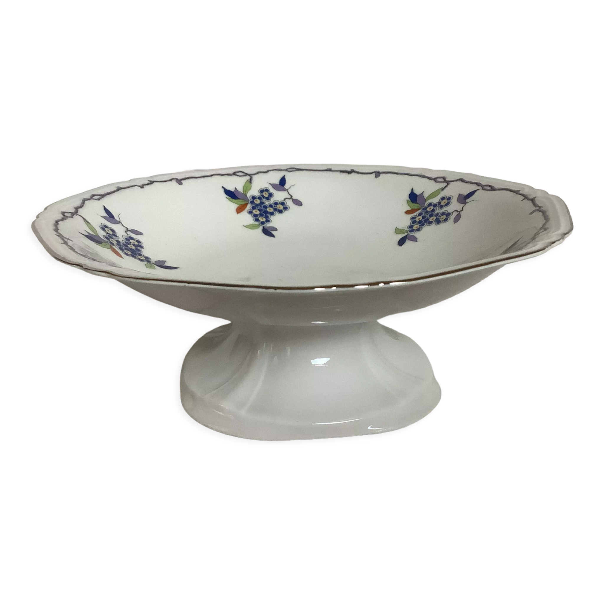 Old shower tray with silver trim and forget-me-not flowers.