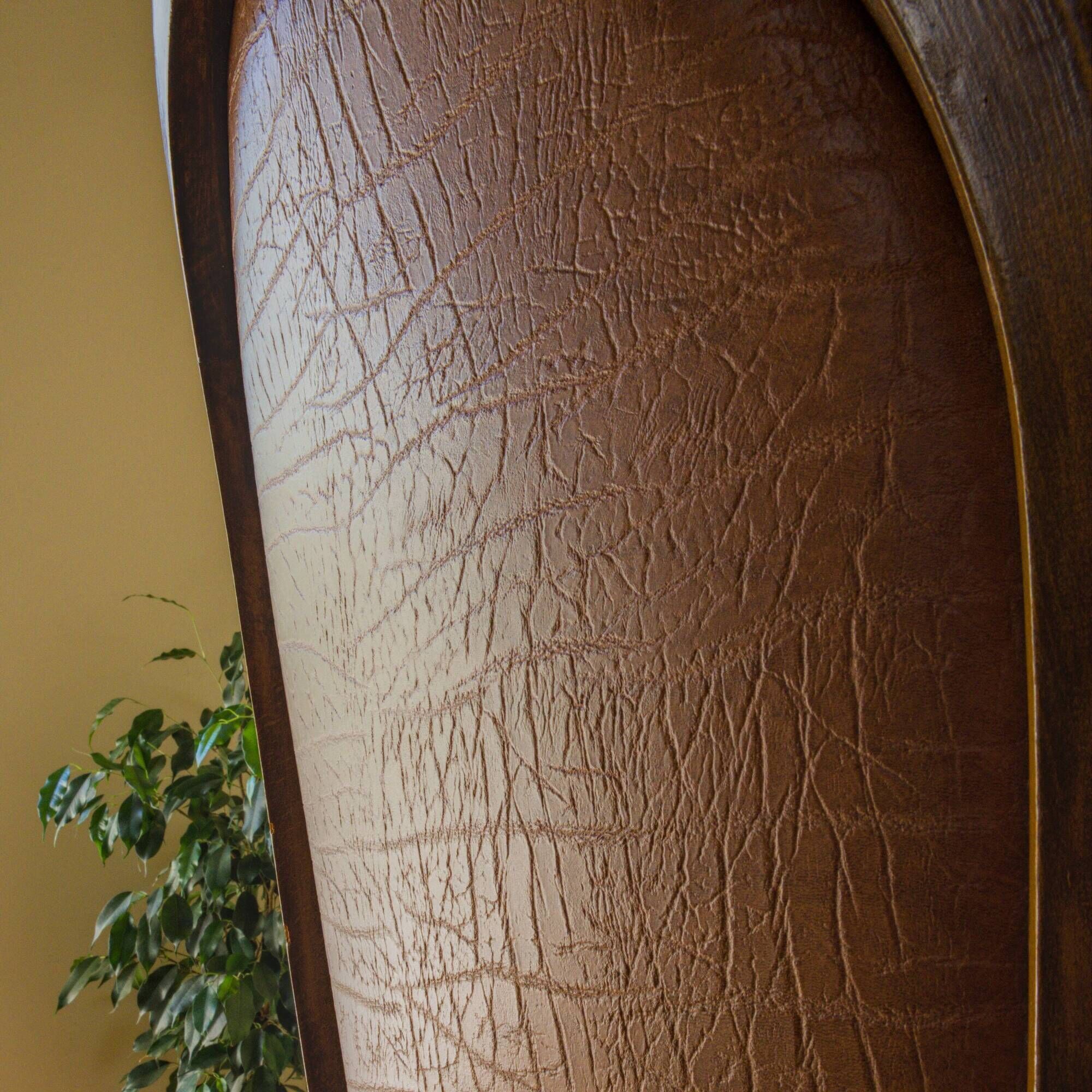 Antique armchair in solid wood and patinated brown leather, early 20th century.