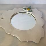 Ceramic mirror with serrated edge and a flower