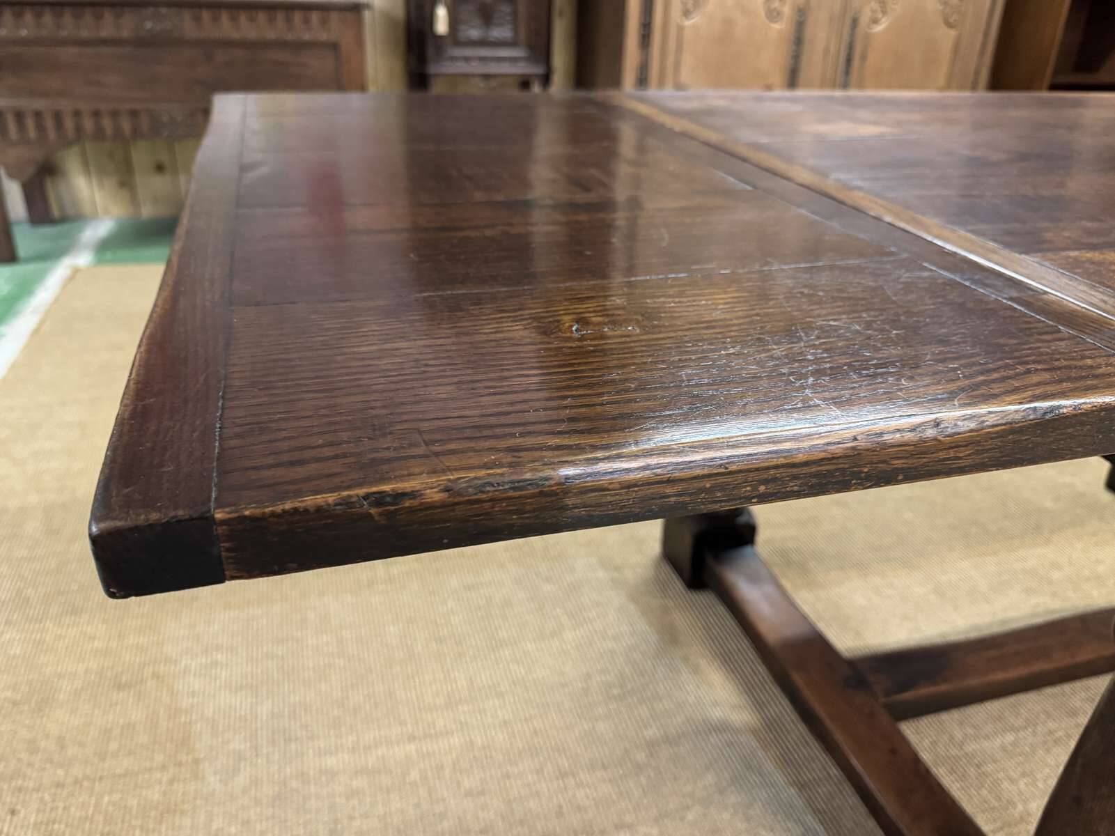 English monastery table with extensions from the late 19th century in elm and oak.