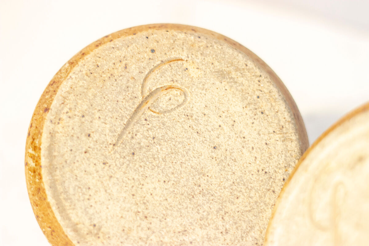 2 stoneware shells, unidentified signature