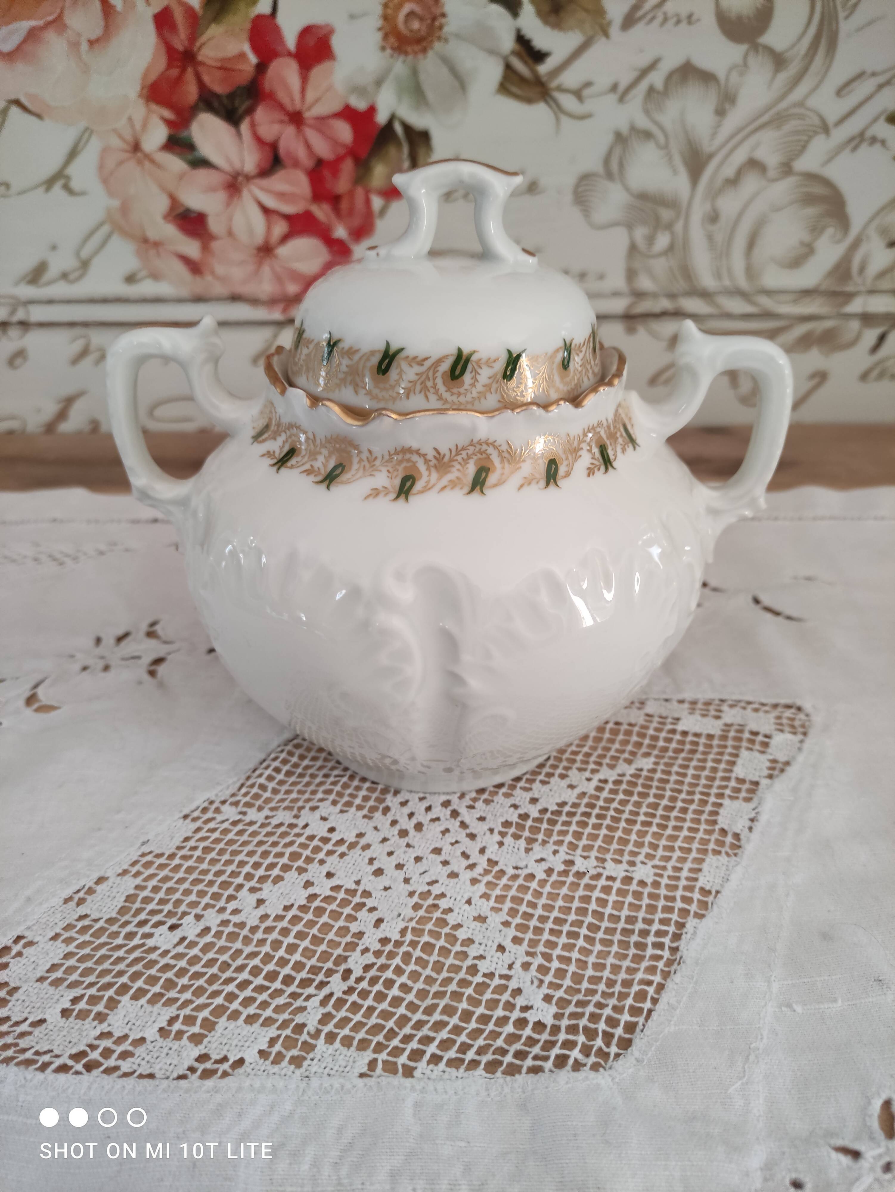 White porcelain sugar bowl decoration in relief and green and gold frieze