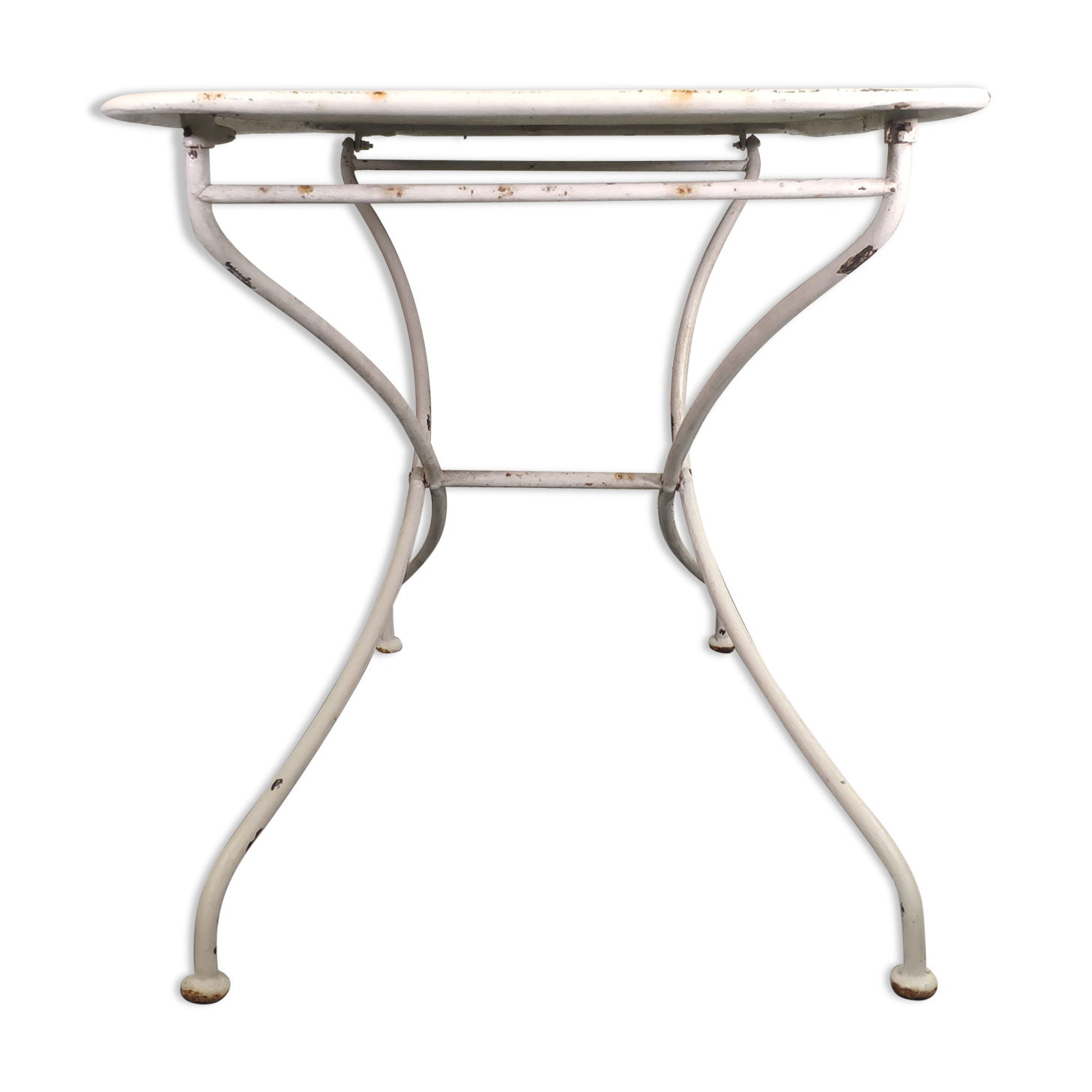 Old folding garden table in white wrought iron