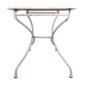 Old folding garden table in white wrought iron