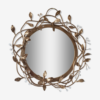 Round mirror in gilded wrought iron and leaves