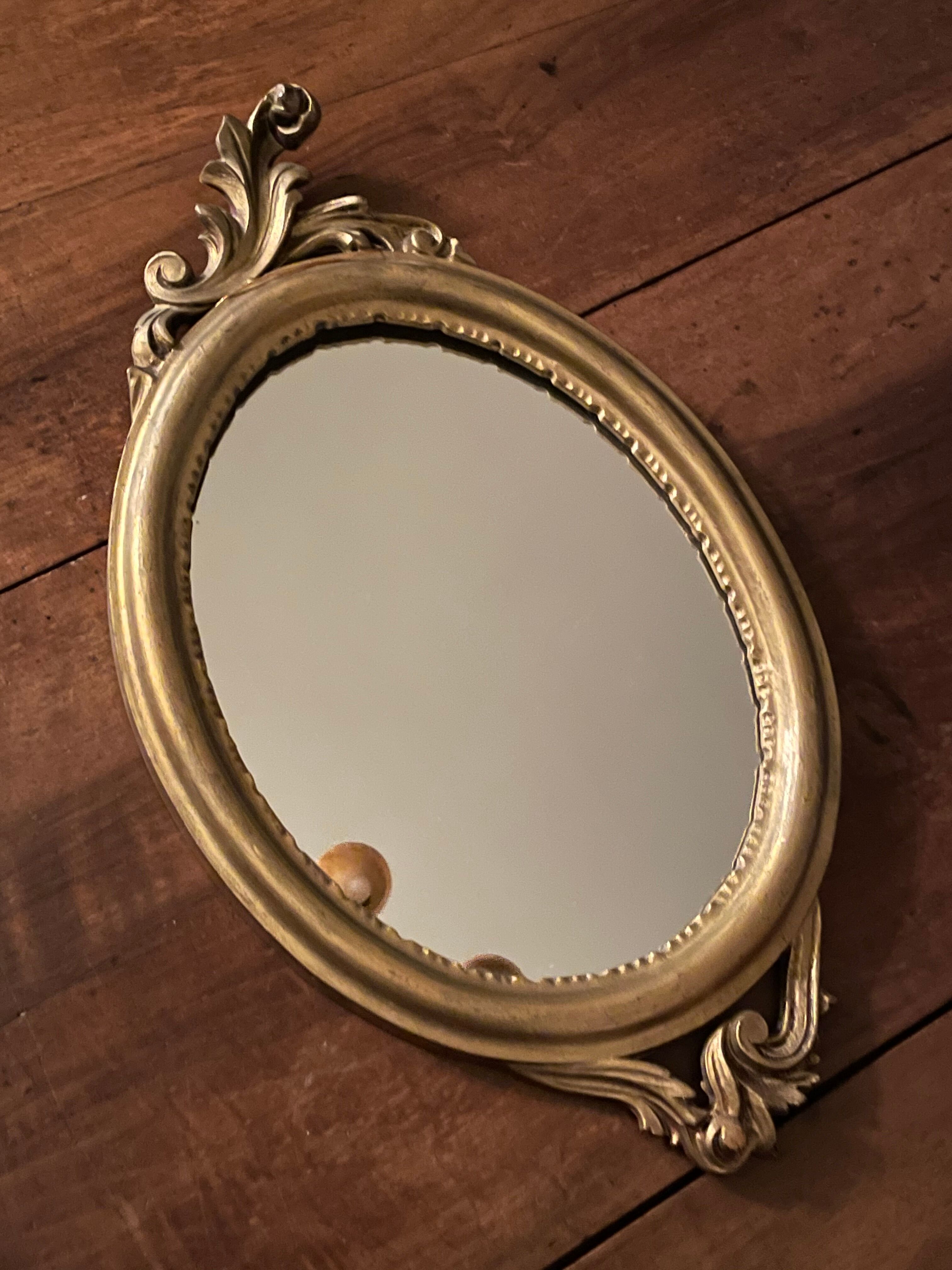 Golden oval mirror