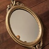 Golden oval mirror