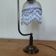 Retro brass lamp with a glass shade and bead fringes.