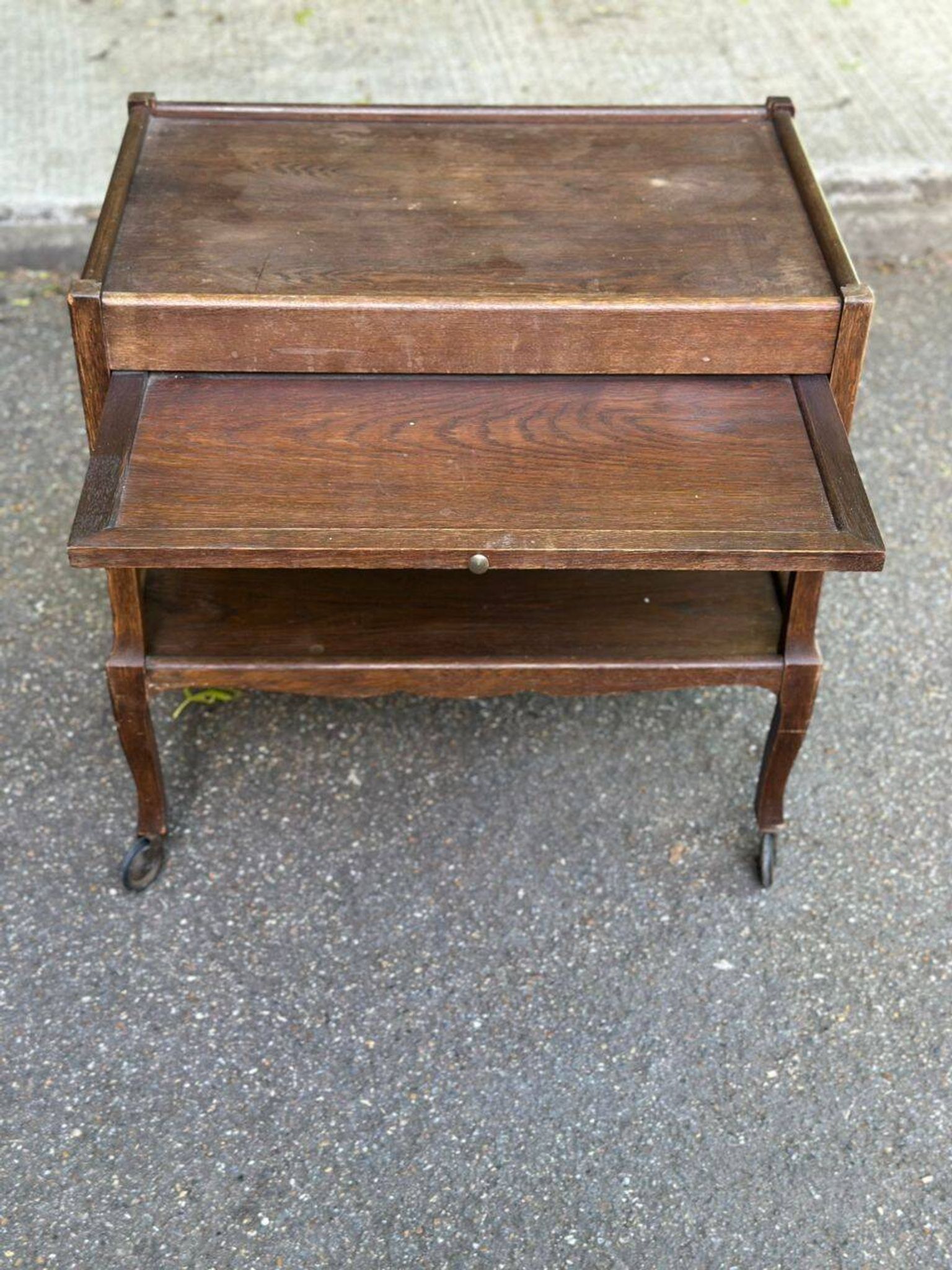 Extendable wooden bar trolley with a glass top from the 1930s.