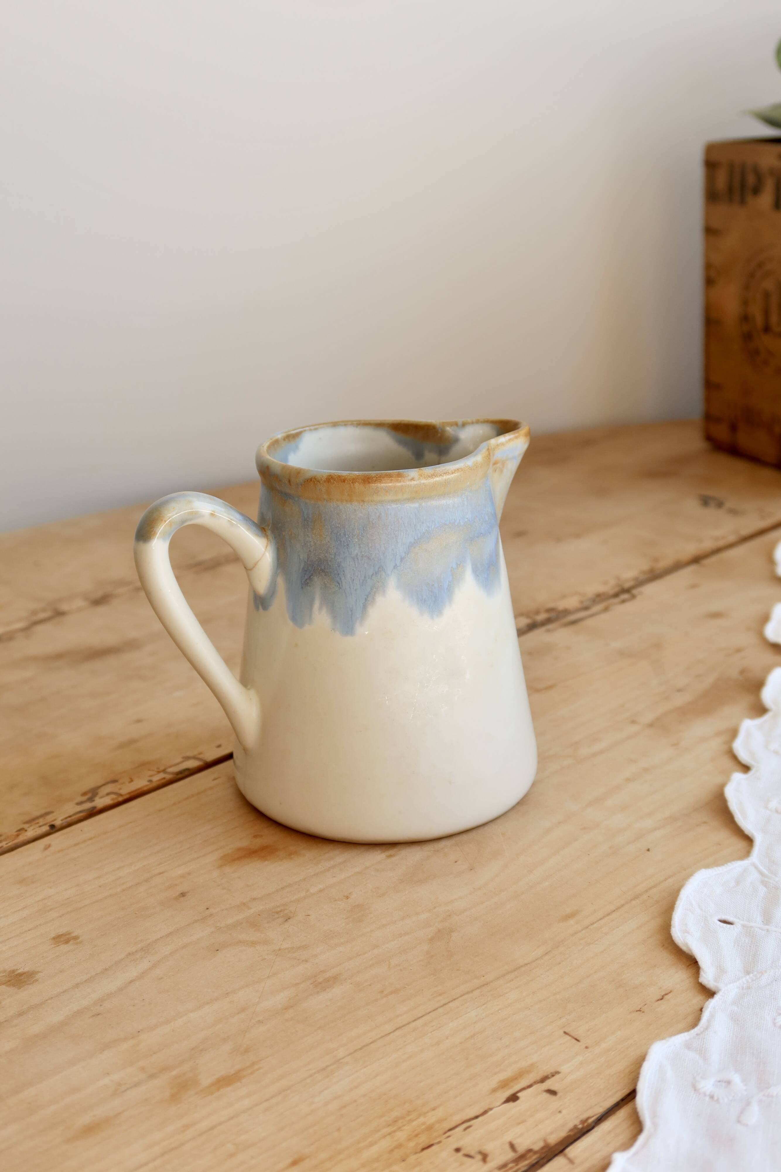 Vintage ceramic milk jug with a blue and taupe gradient glaze.