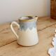 Vintage ceramic milk jug with a blue and taupe gradient glaze.