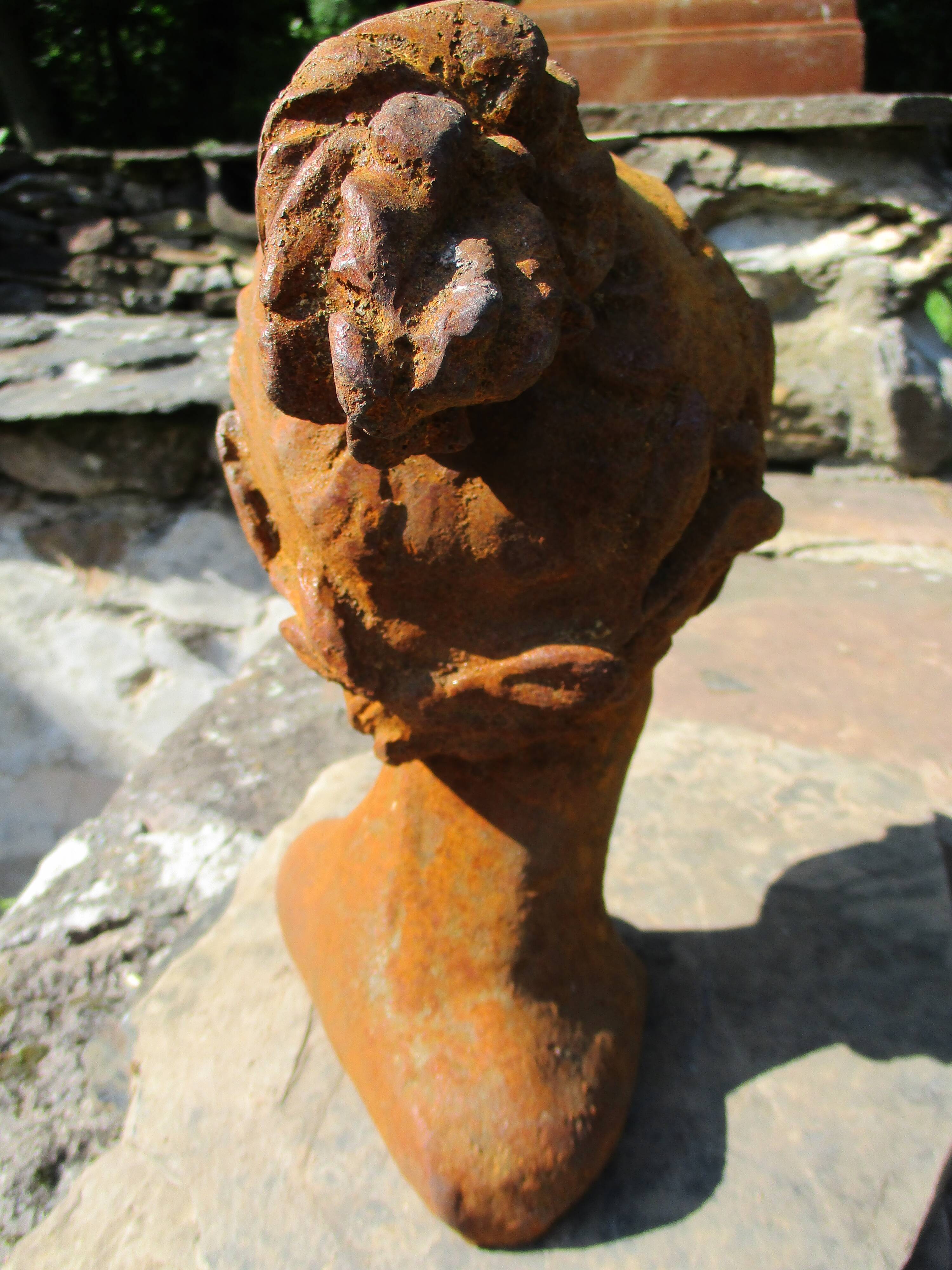 Cast iron sculpture of a woman.