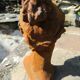 Cast iron sculpture of a woman.