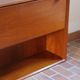 Vintage teak bar cabinet with black glass interior.