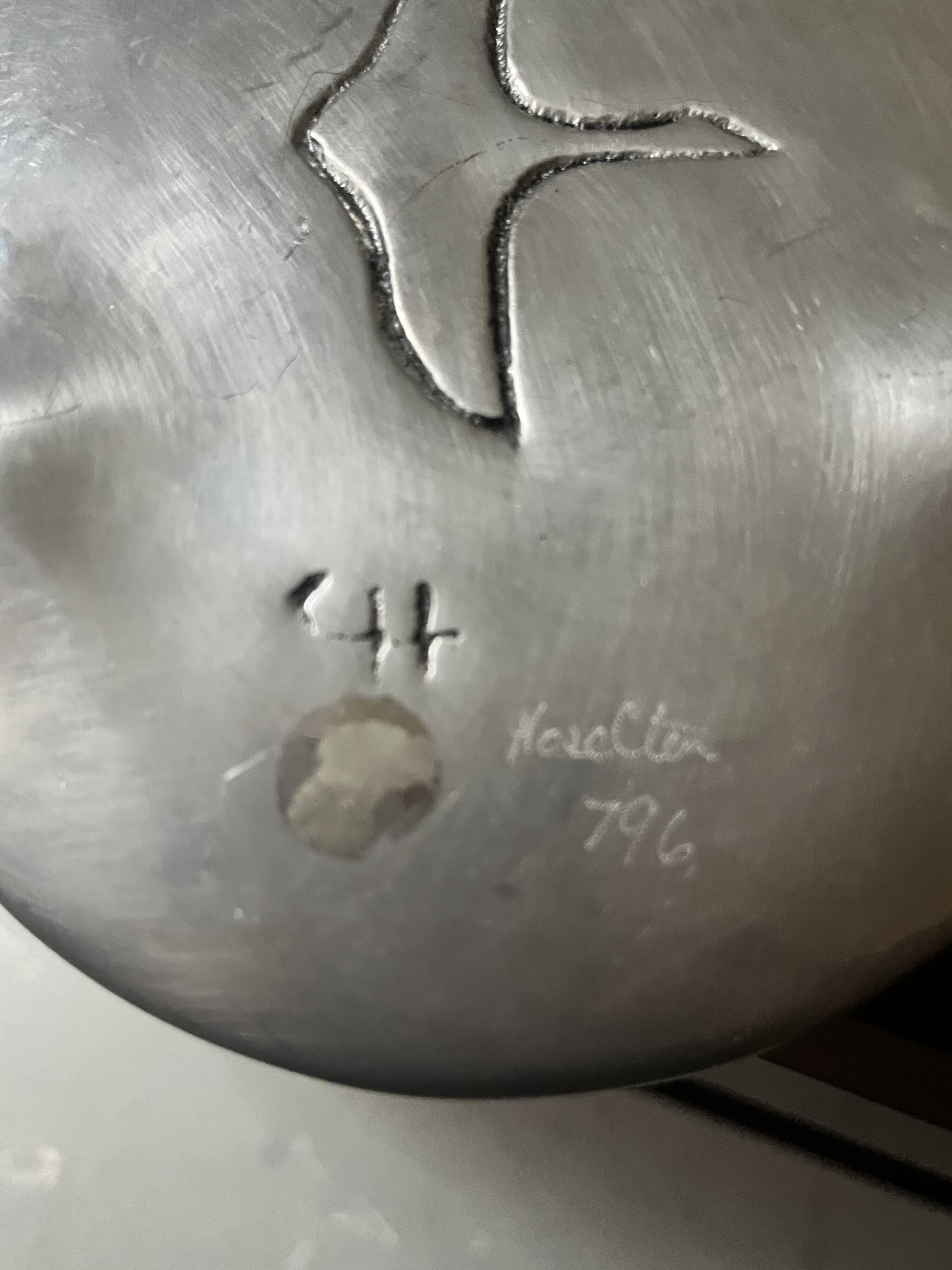 polished aluminum pocket emptier, signed and stamped in the mass