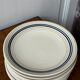 Set of 9 blue and beige striped plates.