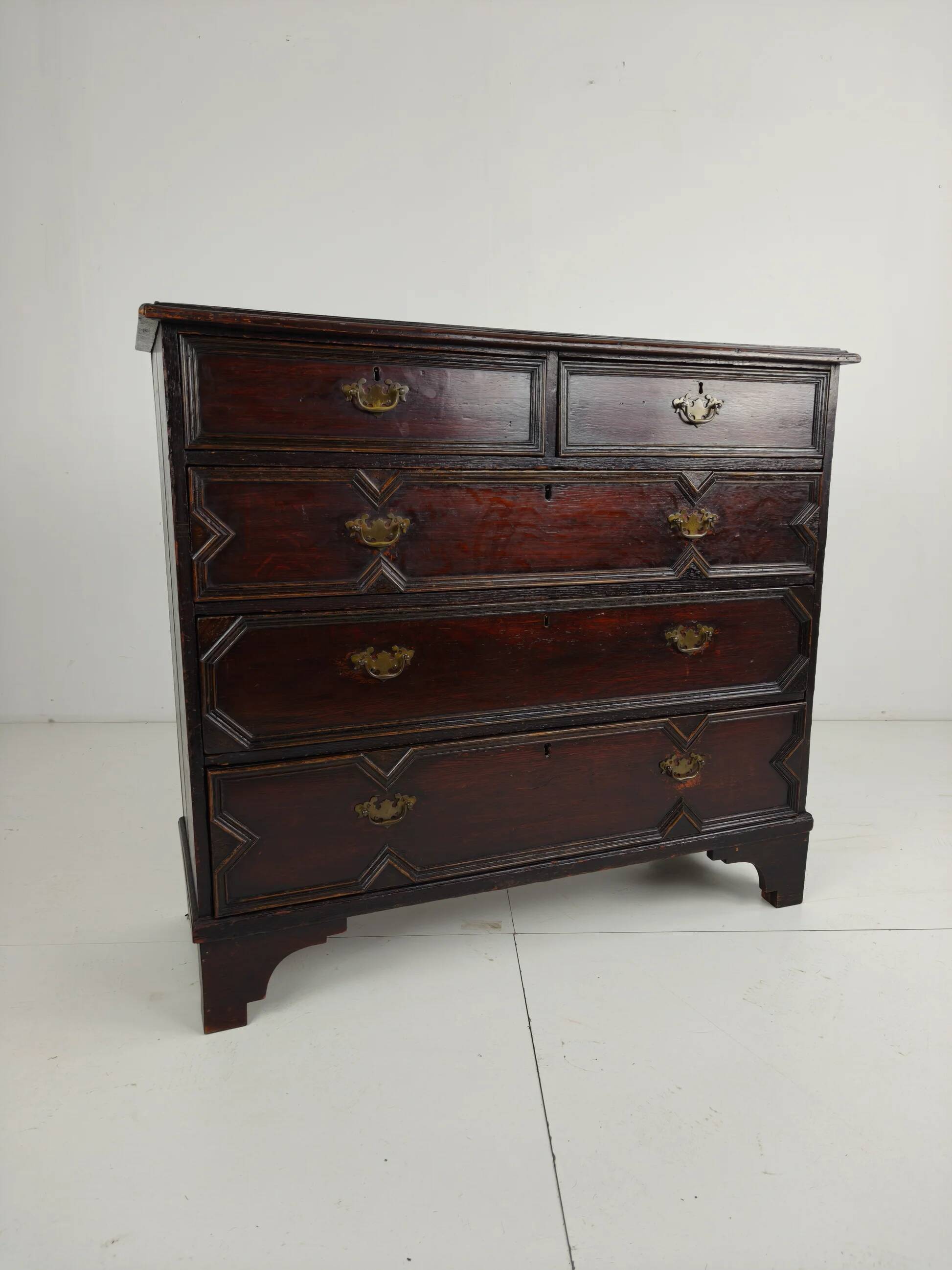 English geometric-panelled oak chest of drawers, circa 1680