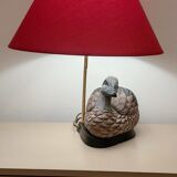 Decorative table lamp with a sculpted duck-shaped base and painted finish.