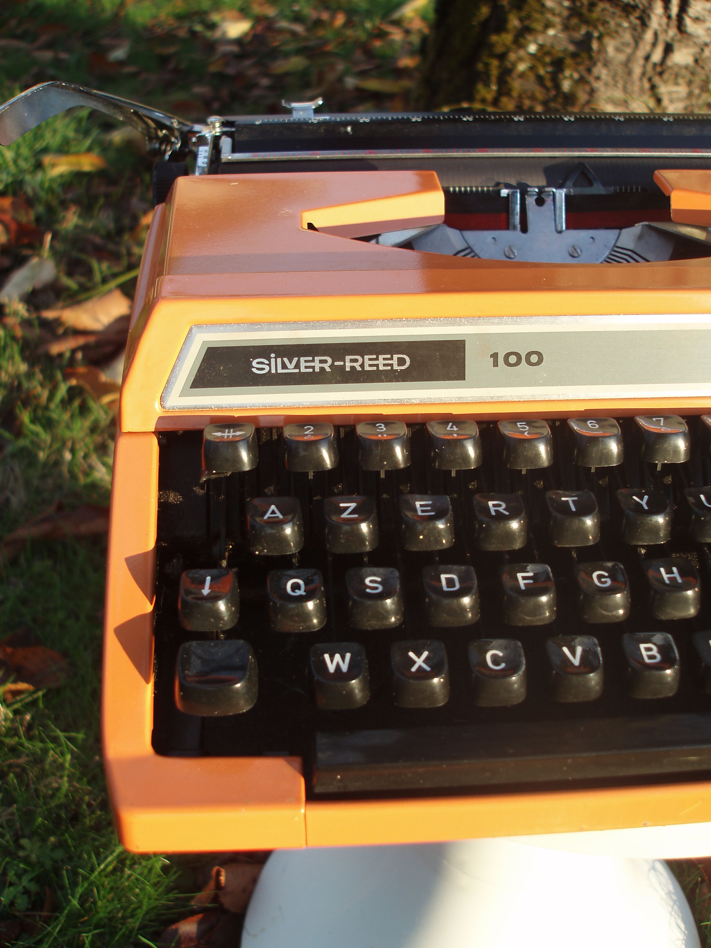Silver reed orange and black typewriter with bag