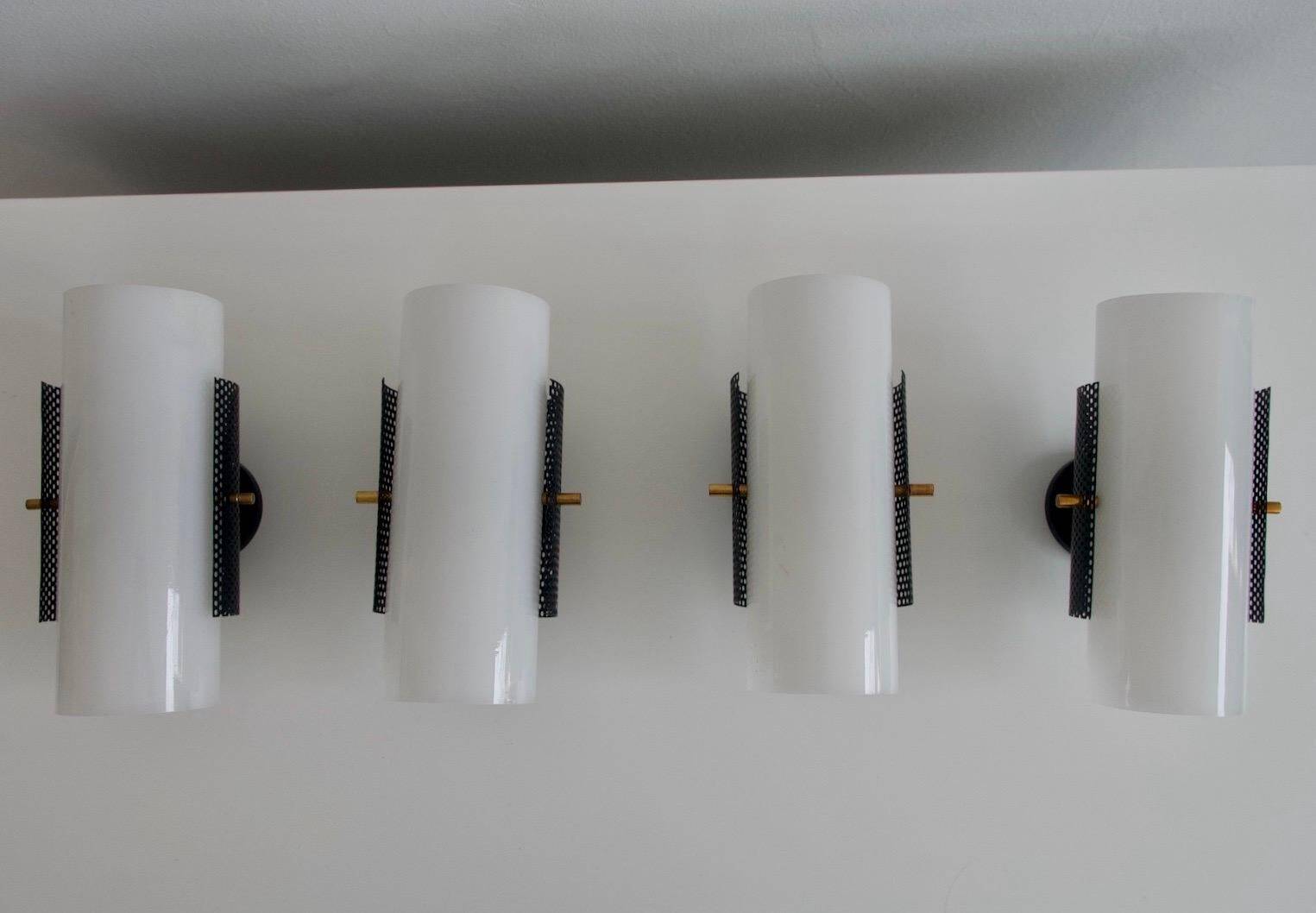 Set of four wall lights in white plexiglass and perforated black metal.