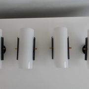 Set of four wall lights in white plexiglass and perforated black metal.