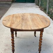 Louis Philippe oval table with shutters, 19th century, solid oak wood, twisted leg