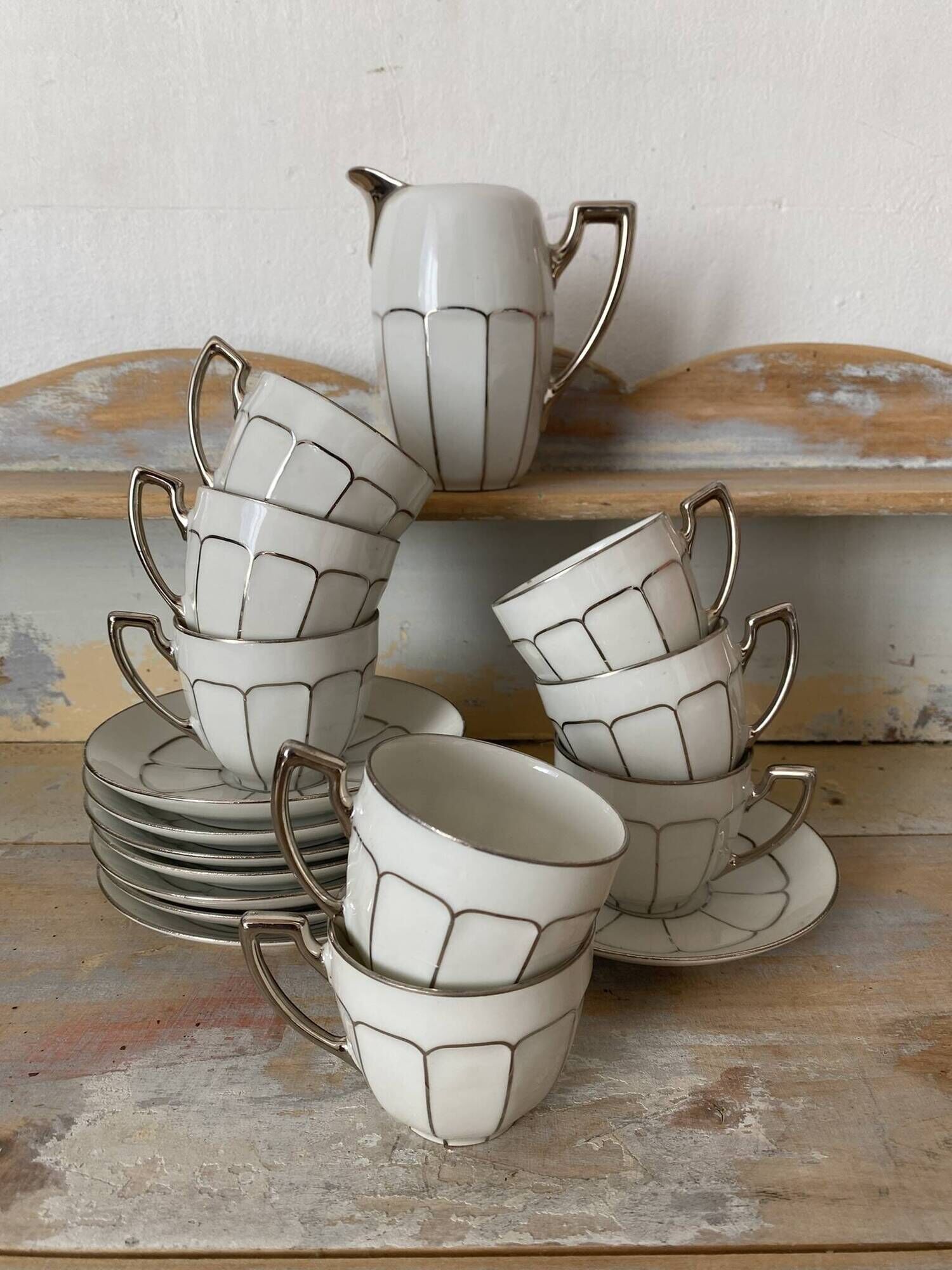White and silver Limoges porcelain coffee cups and saucers.