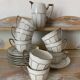 White and silver Limoges porcelain coffee cups and saucers.