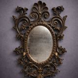 Antique Louis XV style mirror, richly carved with scrollwork, shells, and foliage.