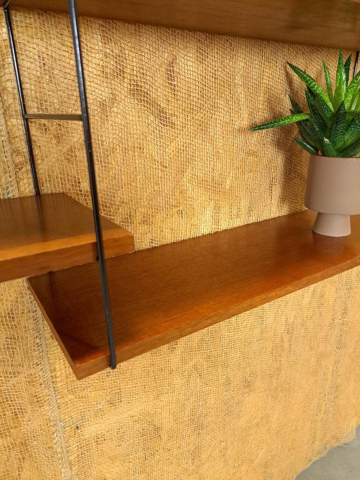 Wall rack with shelves and steel holders, dark wall system