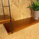 Wall rack with shelves and steel holders, dark wall system