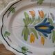 Old oval dish with floral motif called black bottom with staples