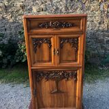 Art Deco sideboard bar cabinet in solid walnut with 3 doors and 1 richly carved tilting false drawer.