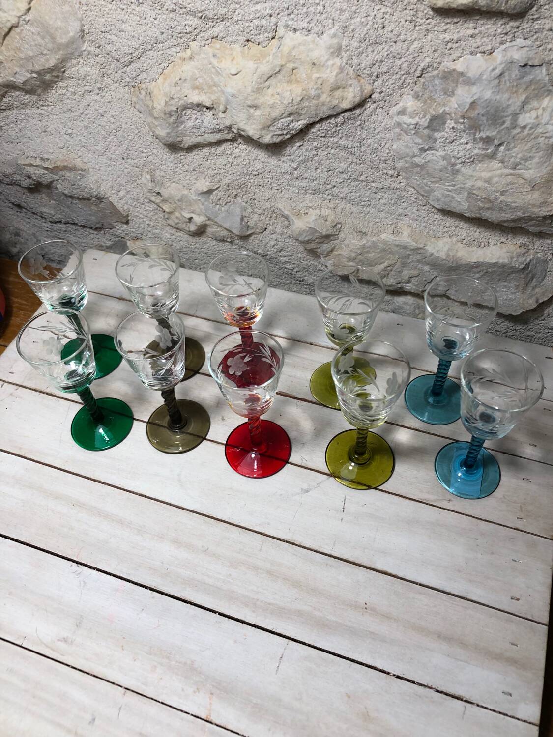 Antique and rare! Sold in a set of 12 colorful twisted stemmed glasses engraved with flowers and leaves