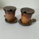 Pair of glazed stoneware cups with saucers and lids