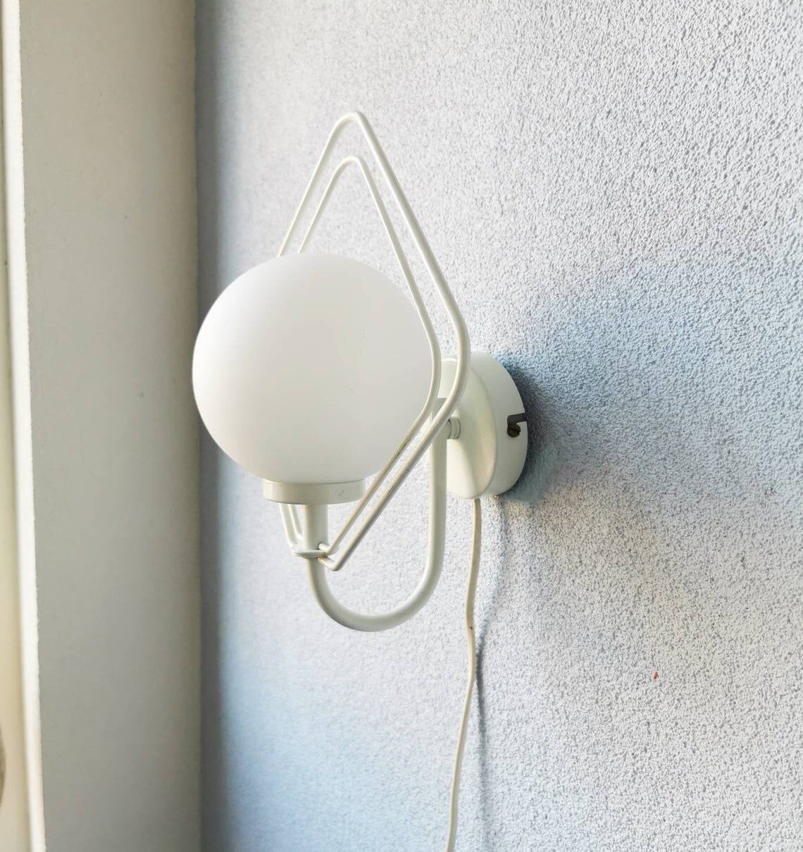 Metal applique with 80s glass sphere