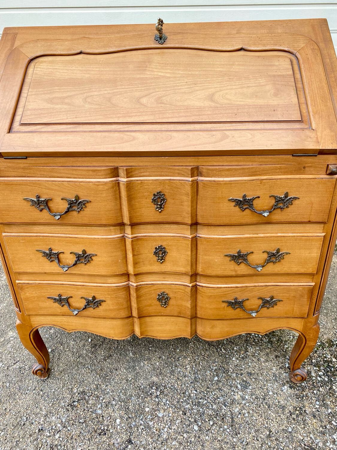 Louis XV style writing desk with a curved back.