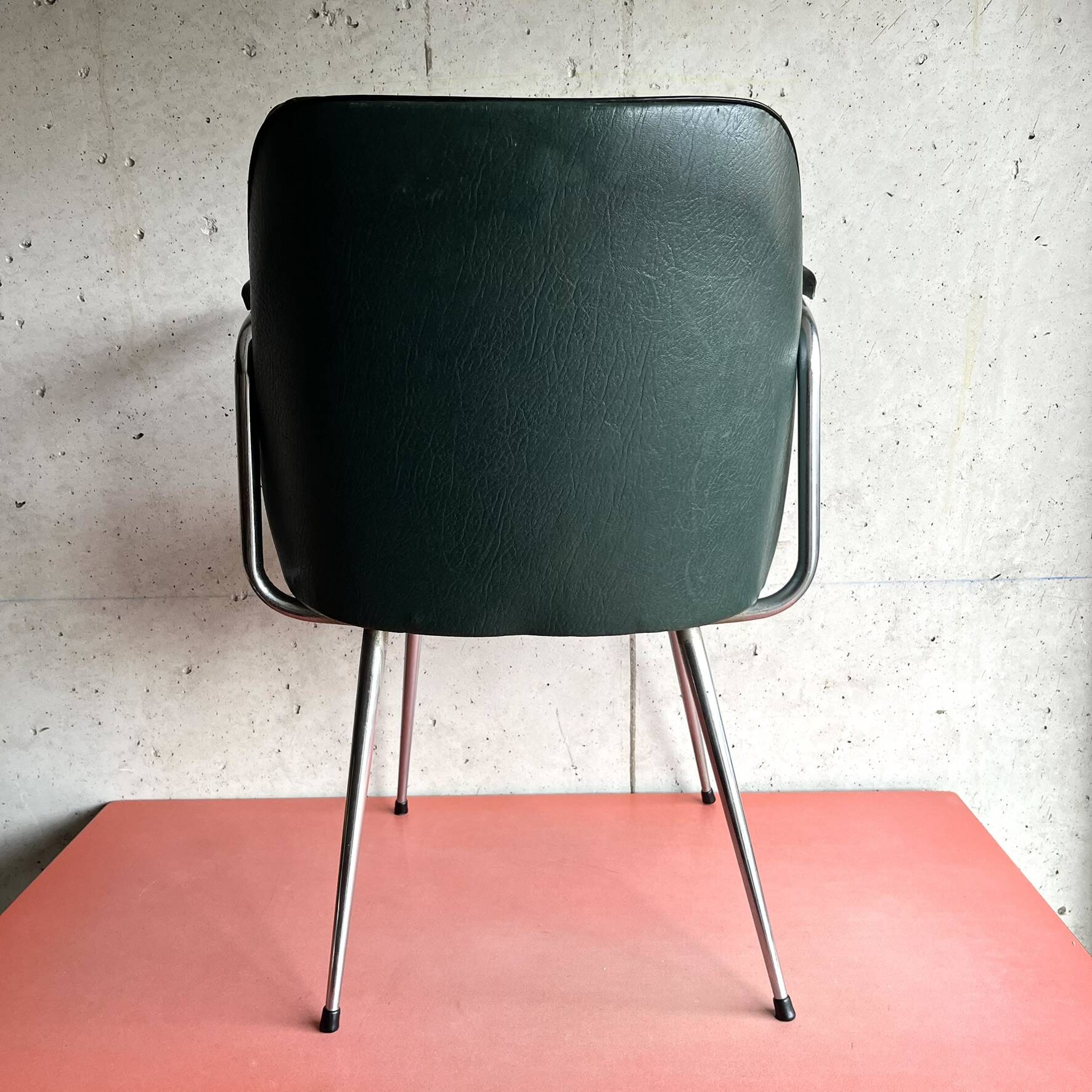 Vintage green faux leather and chrome armchair