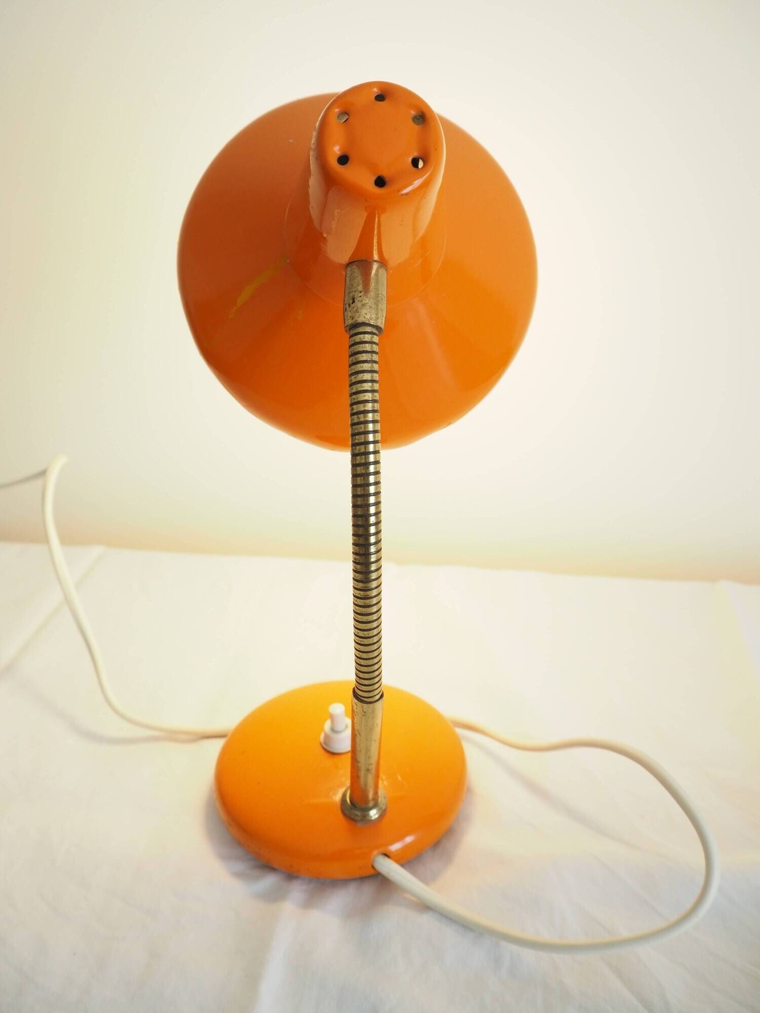 Orange colored metal desk lamp from the 1960s-1970s