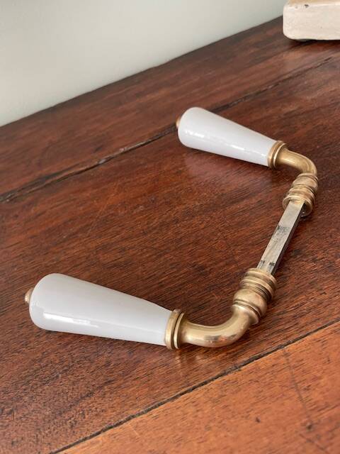 pair of porcelain handle levers with brass rods, antique