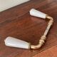 pair of porcelain handle levers with brass rods, antique